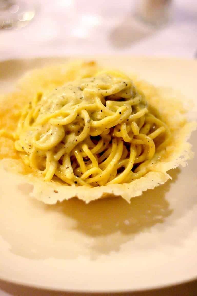Pasta cacio e pepe served in a Parmigiano Reggiano wafer, Italian food