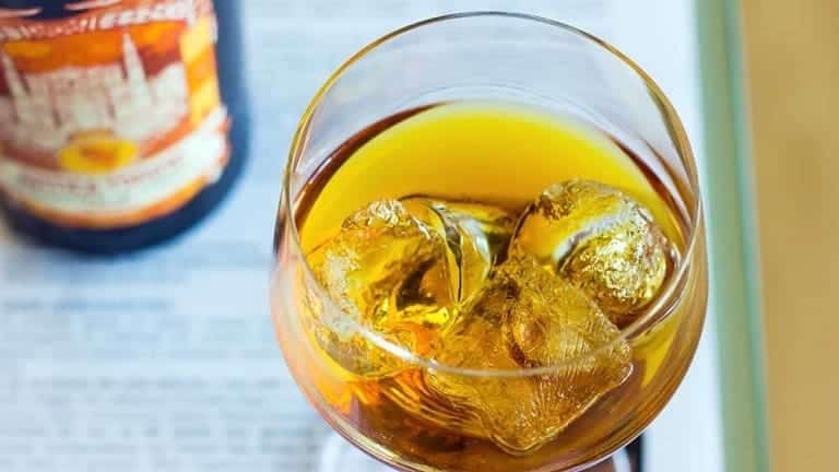 Italian aperitif with sweet vermouth. soda, ice lemon zest and orange