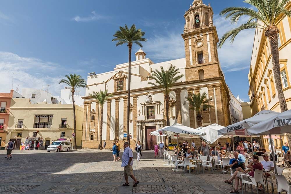 Majestic Cadiz Cathedral standing tall against a blue sky, showcasing its intricate Gothic architecture and grandeur