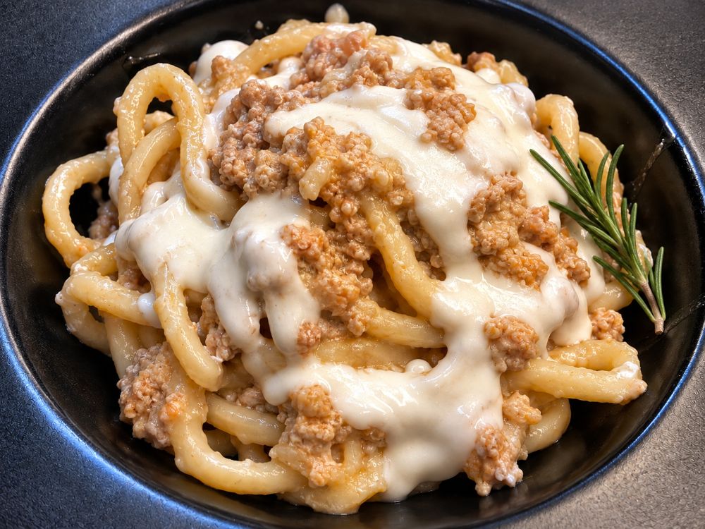 Pici with meat ragù and burrata sauce